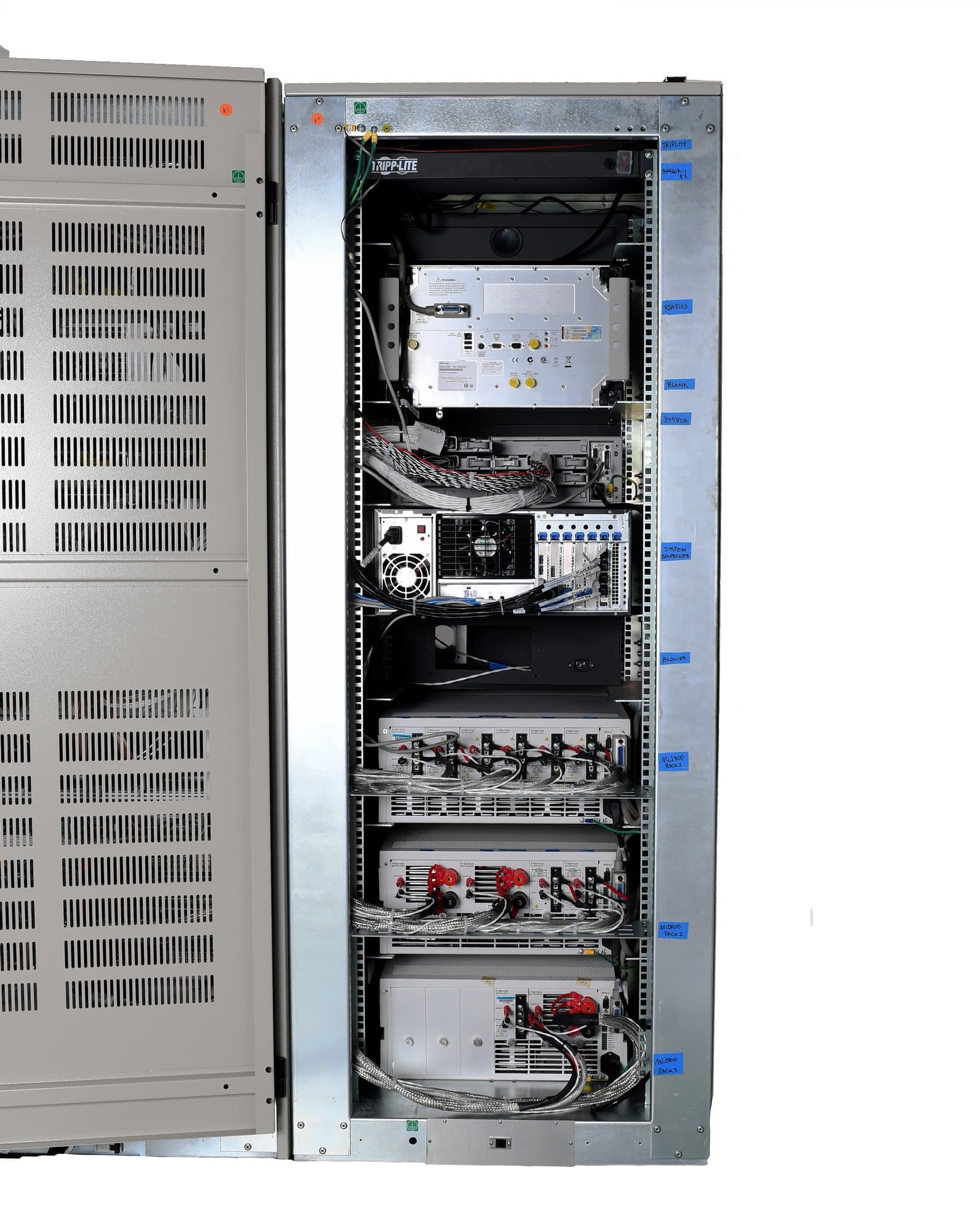 Interior of an Intepro test rack, showing the supplies, protection and wiring behind the front panel